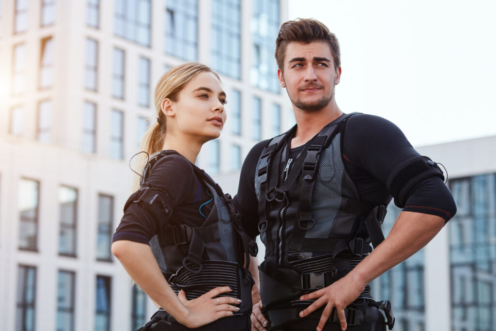 young adults in EMS training suits outdoors.