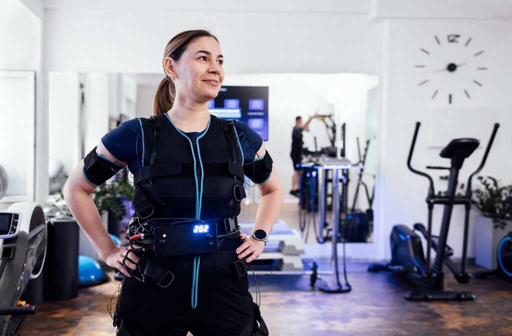  A young woman smiling after choosing the best EMS suit for her.